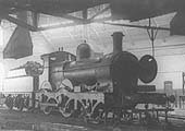 GWR 2-4-0 Barnum class No 3210 an outside-framed locomotive is seen inside one of the roundhouses undergoing repair work on its inside cylinders