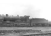 GWR 4-4-0 No 3403 'Trinidad', a Bulldog class outside-framed locomotive, is seen standing alongside the 'Loco' coal wagons