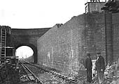Looking towards Tyseley station as workmen are seen working on building Stockfield Road bridge's new abutment adjacent to the up main line
