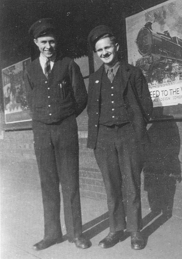 Porters Don Martin and Ted Breakwell are seen standing on Tyseley down relief Platform 4 posed in front of the 'Speed to the West' classic poster