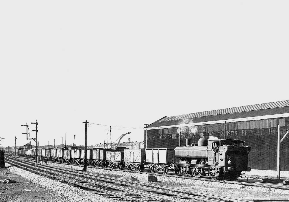 Ex-GWR 0-6-0PT 57xx Class No 8700 hauls a rake of wagons along thea train from Bordesley Junction in 1958 up main with 