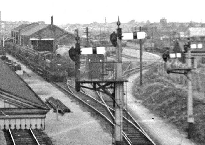 Close up showing the unidentified ex-GWR 0-6-0PT 'Pannier Tank' shunting in the goods yard with a train of wagons carrying sets of rail panels