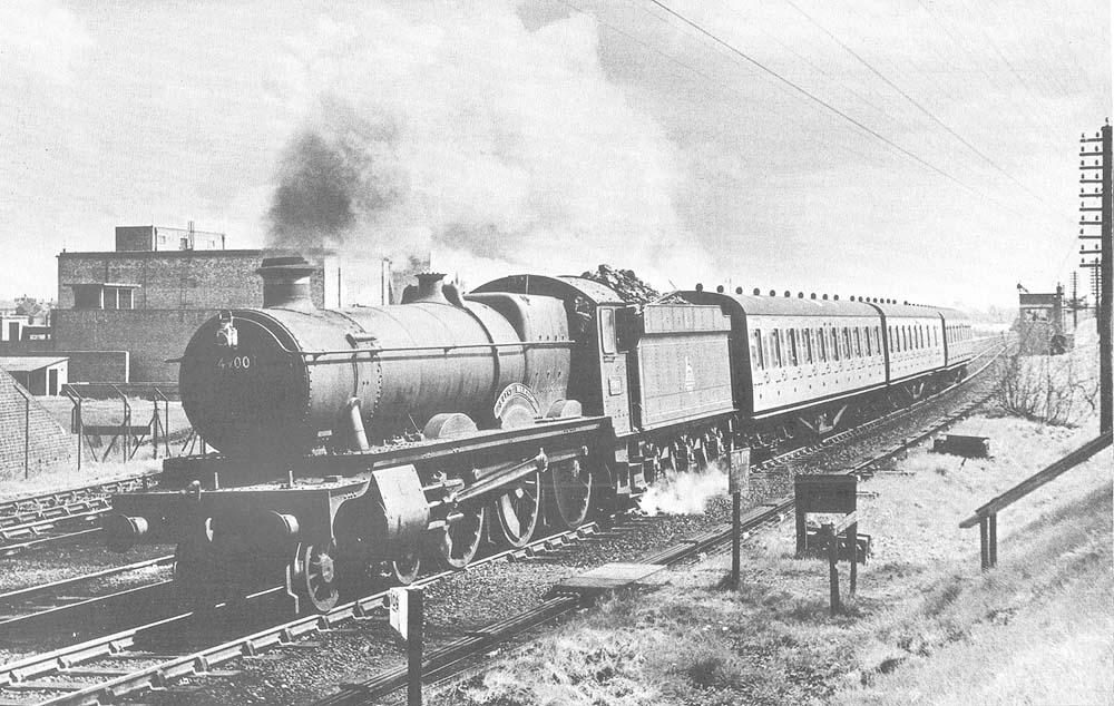 Ex-Great Western Railway 49xx (Hall) class No 4900 ‘Saint Martin’ passes the Warwick Cold Store on the down main line with a local passenger service
