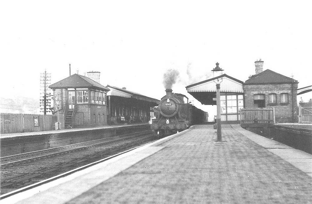 Ex-Great Western Railway 43xx class 2-6-0 No 6363 heads north through Warwick Station with a down class H unfitted freight train in the early 1950s