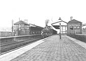 Ex-GWR 43xx class 2-6-0 No 6363 heads north through Warwick Station with a down Class H unfitted freight train