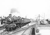 Ex-GWR 4-6-0 Saint Class No 2933 'Bilbury Court', relegated to secondary duties, arrives on a down stopping train