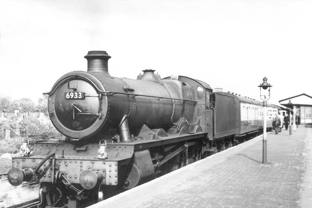 Ex-GWR 4-6-0 Hall class No 6933 'Bintles Hall' stands at the head of a down express train bound for Birmingham Snow Hill