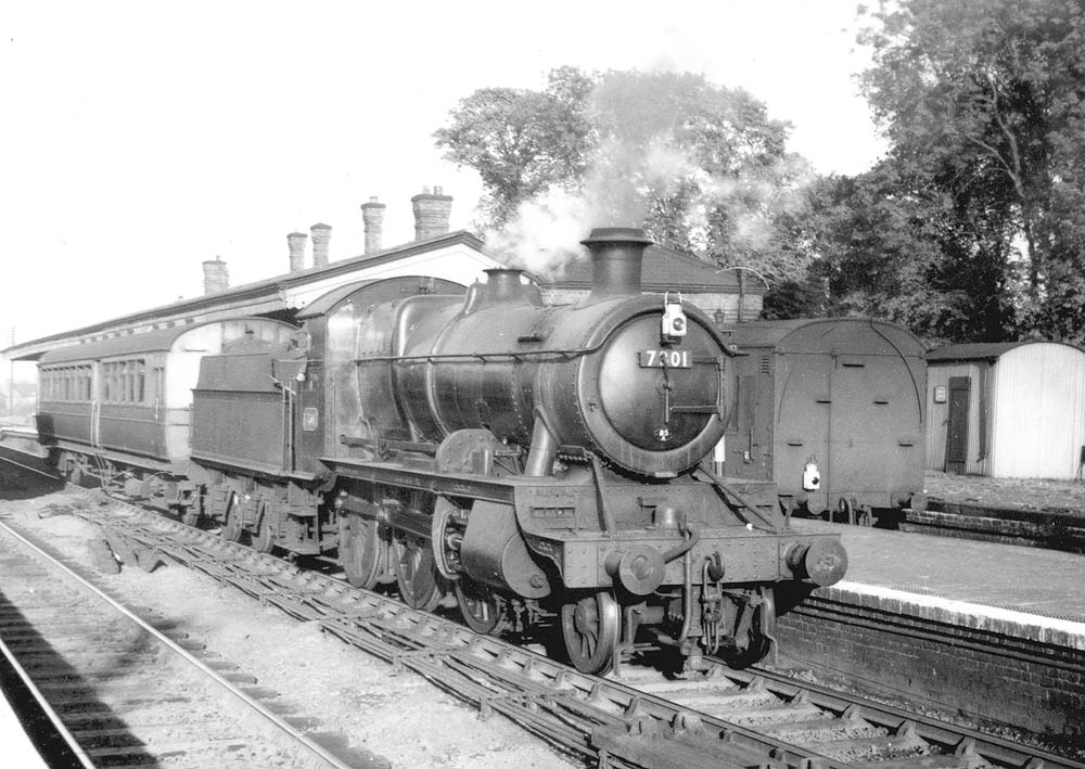 Ex-GWR 2-6-0 43xx class Mogul No 7301 passes through the station on a down one-coach railcar trailer service in June 1951