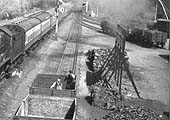 Close up showing workmen in the process of unloading coal prior to stacking the coal on the ground circa 1938