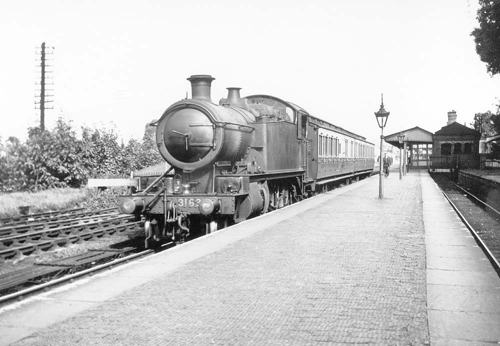 GWR 2-6-2T Prairie Tank No 3162 stands in the station on a down two-coach local train made up with Clerestory coaches
