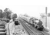 GWR 4-6-0 No 6000 'King George V' the pioneer of this class of locomotives hurries past Warwick Corporation's gas work sidings with an up express