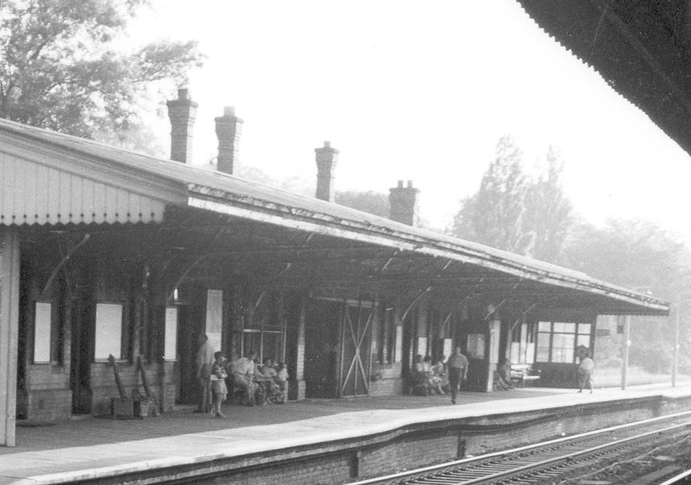 Close up of the down platform and main station buildings with the entrance in the middle of the building and a telephone box to its right