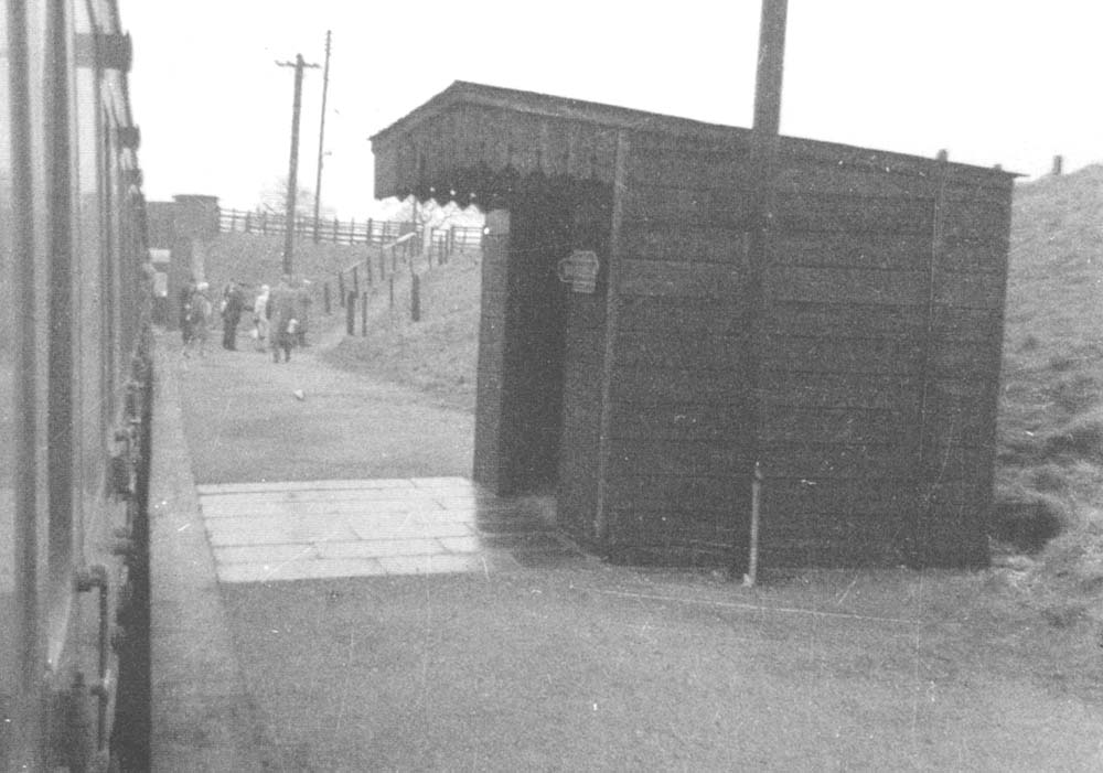 View of the down platform's timber framed and clad passenger shelter and the pathways leading down to the Whitlock End platform