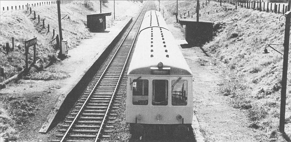Looking south towards Grimes Hill & Wythall from Tilehouse Lane bridge as a three-car DMU service is seen departing for Birmingham Moor Street