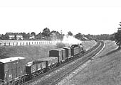 Another view of ex-GWR 4-6-0 Hall class No 4905 'Barton Hall as it moves away from the Halt at the head of an up Class D express freight service on 8th July 1962