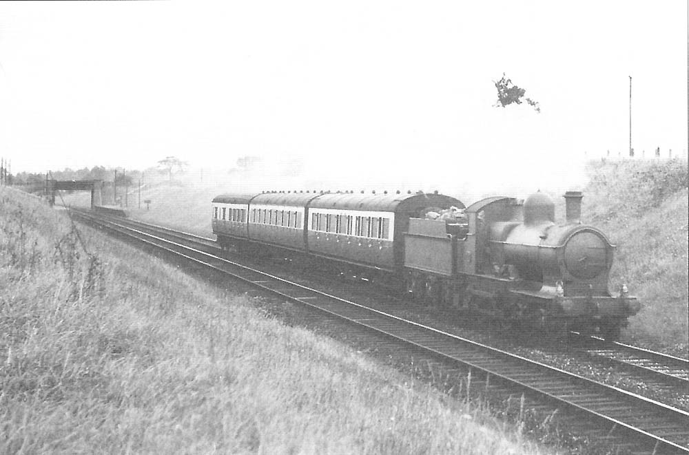 GWR 4-4-0 '32xx Class' No 3202 leaves Whitlocks End Halt on a three carriage local service to Henley in Arden