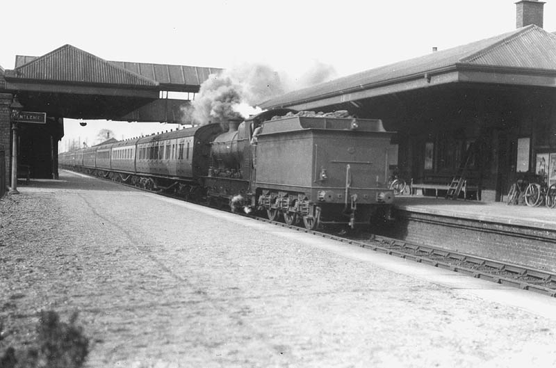 GWR 2-6-0 Aberdare class No 2632 is seen running tender first with a long empty coaching stock working as it passes through the station