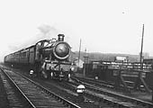 GWR 4-6-0 49xx class No 4935 'Ketley Hall' is seen at the head of an up express train as it passes by the goods yard