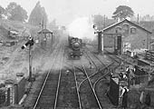 Close up showing the signal box and goods shed and yard whilst an unknown GWR 4-6-0 storms past the signal