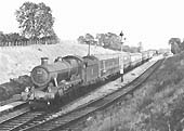 BR built 4-6-0 Modified Hall No 7918 'Rhose Wood Hall' reaches the top of Wilmcote Bank unaided in June 1957