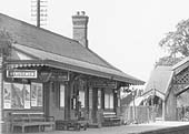 Close up showing the up platform and main station building,  the footpath to Station Road and the bottom of the steps of the passenger footbridge