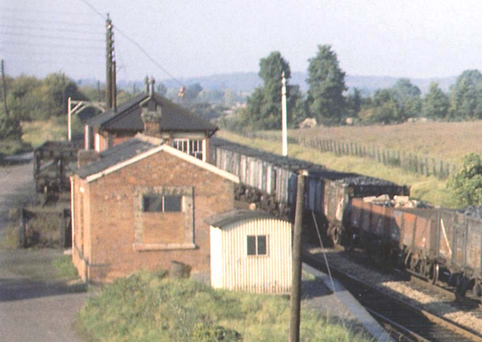 Close up showing the original 1860 station building now being used as accommodation in the goods yard with Wilmcote Signal Box behind