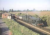British Railways built 4-6-0 Modified Hall class No 7918 'Rhose Wood Hall' passes the original Wilmcote station whilst at the head of a down mineral train