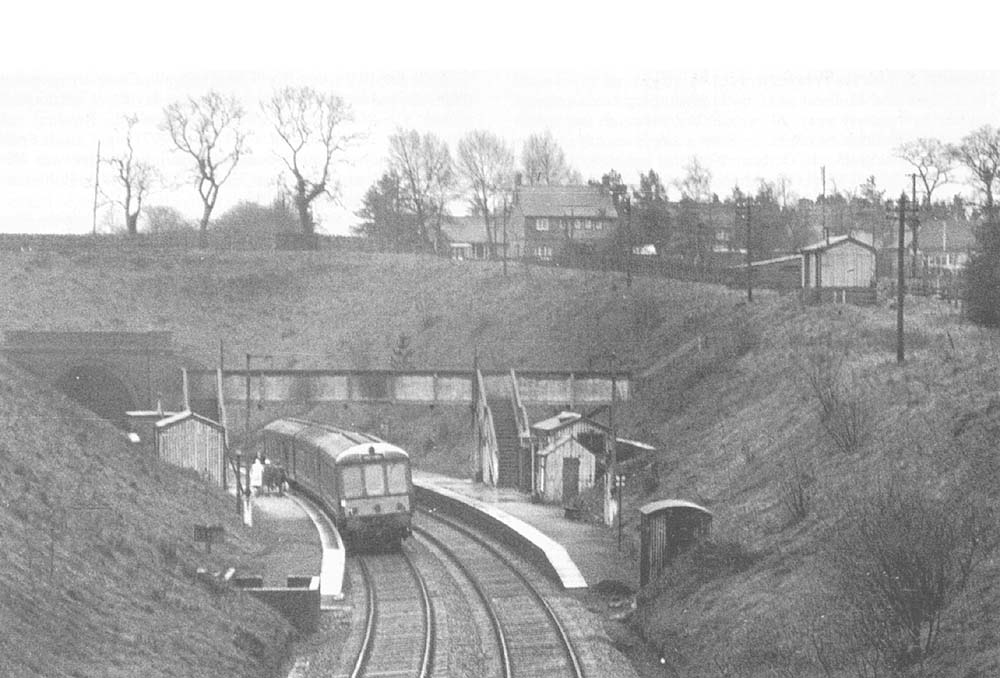 Looking in the direction of Stratford upon Avon from Wood End Lane road bridge showing the booking office on the top of the embankment