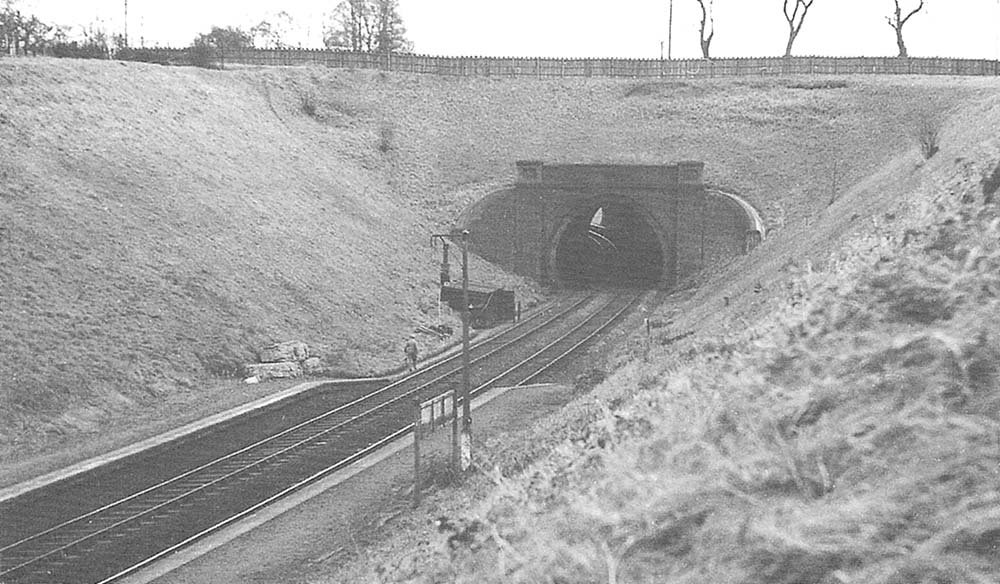 An elevated view of the tunnel from the footpath on the embankment to the up platform showing the sharp curve of the tunnel bore