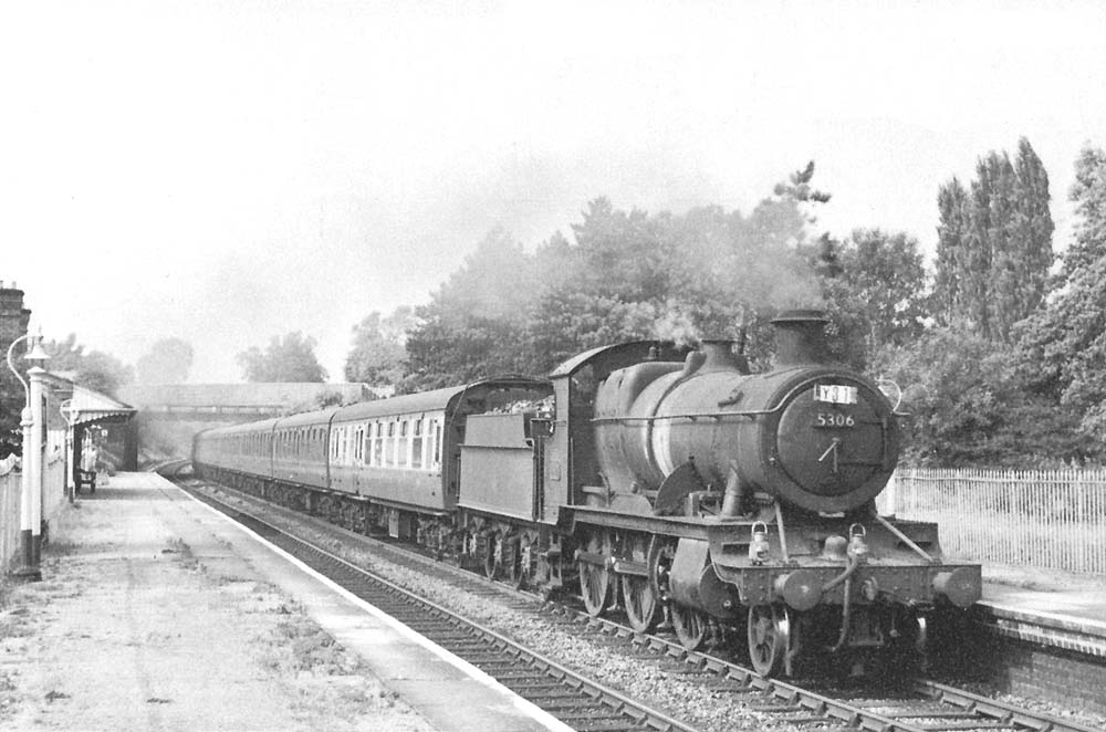 Ex-GWR 2-6-0 43xx Class No 5306 passes through Yardley Wood on a down empty stock working in August 1959