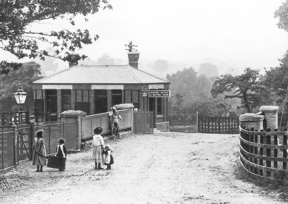 Close up showing Yardley Wood's booking office and waiting room and the access to the down platform from the gated entrance on the left