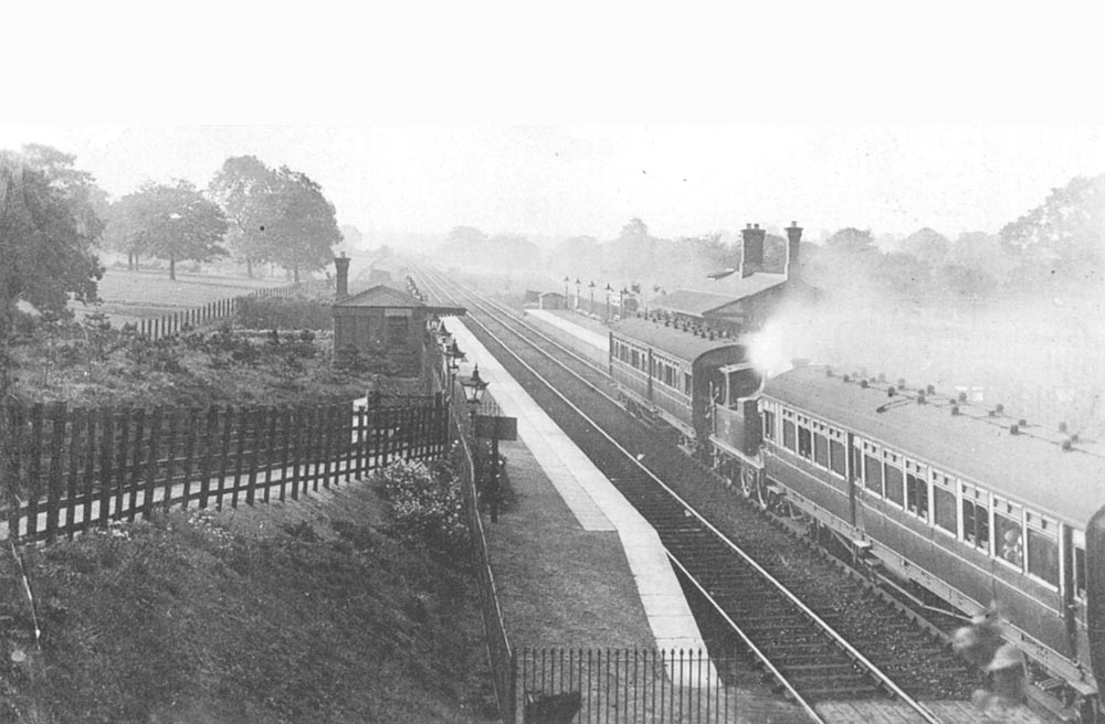 Looking towards Stratford upon Avon as an unidentified 'motor fitted' GWR 517 class 0-4-2T locomotive propels a 'push-pull' train from Yardley Wood