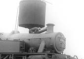 Close up showing the fireman filling the side tanks of the LMS 2-6-0T from the parachute water tank