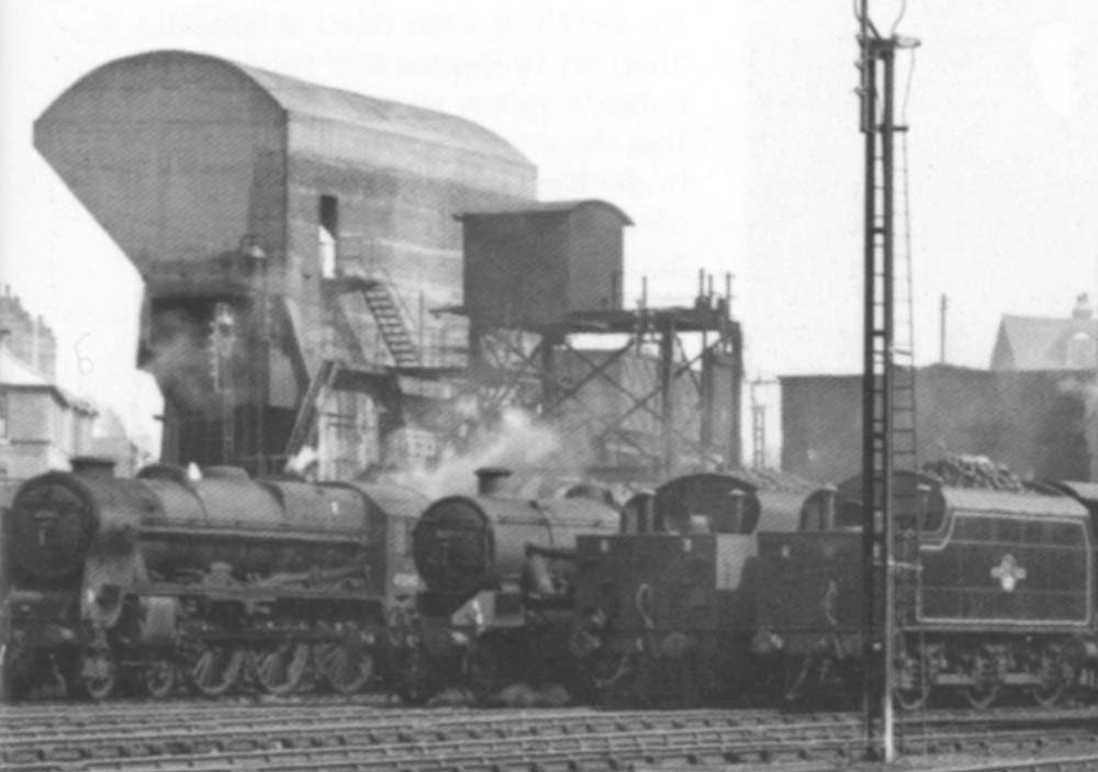 Close up showing rebuilt Patriot class No 45545 'Planet' stabled together with other locomotives in front of the shed