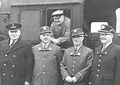 Fred Gibbs poses from the cab with colleagues wearing a mix of old and new British Railways uniforms