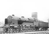 Ex-LNWR 4-6-0 'large boiler' Claughton class No 6023 'Sir Charles Oust' stands adjacent to the parachute water tank