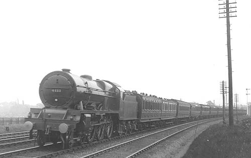 LMS 4-6-0 Royal Scot class No 6111 'Royal Fusilier' is seen at the head of the down 'Mid-day Scot' with a train of ex-LNWR and early LMS coaching stock