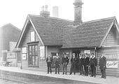 Staff pose for the camera in front of the station's original main building which was situated on the down platform