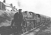 BR Standard 4 4-6-0 No 75052 passes through Bedworth station at the head of an express passenger service on 3rd May 1963