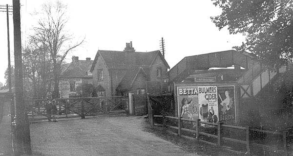 Looking across the level crossing towards the station master's house with the underbridge on the left and the footbridge on the right