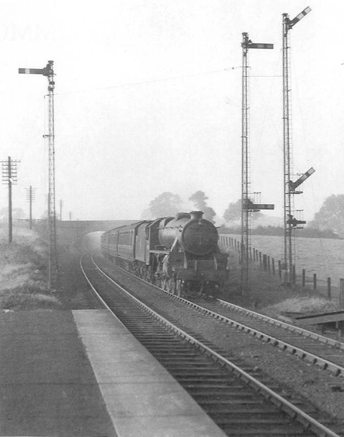 Ex-LMS 4-6-0 5MT No 45020 is seen passing Berkswell's up home signals with an ordinary passenger train for Coventry on 15th October 1951