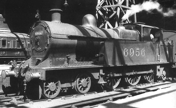 Ex-LNWR 4-4-0 Benbow class No 1974 'Howe' is seen standing at the West end of Platform 2 at the head of a Class 'B' stopping service to Wolverhampton