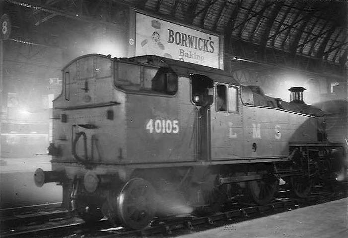 Ex-LMS 3MT 2-6-2T No 40105 is seen passing on the middle road between Platforms 7 and 8 a Class 'J' empty wagon train