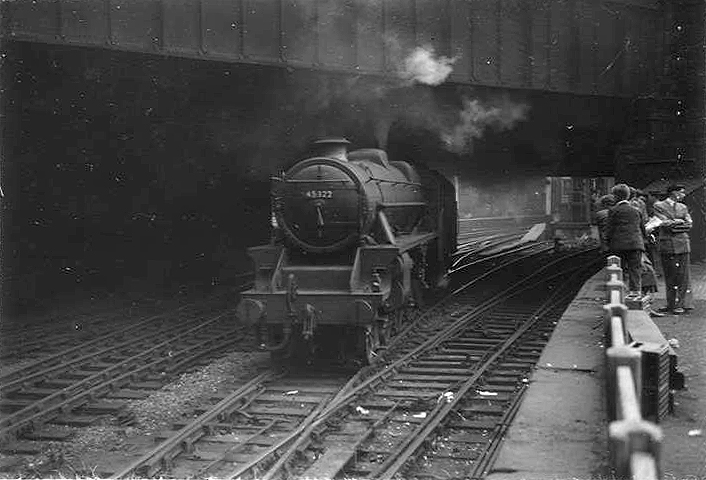 Ex-LMS 5MT 4-6-0 No 45322 is seen running light engine as it passes under Queens Drive bridge and the former LNWR Parcels Office