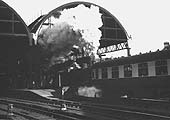 Ex-LMS 4F 0-6-0 No 43875 is seen leaving Platform 9 as it banks a heavy express train through the tunnel on the West Suburban Railway