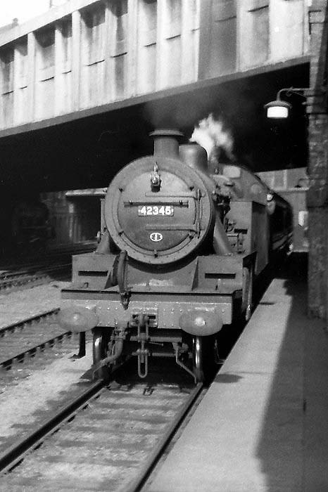 Ex-LMS 4MT 2-6-4T No 42345 is seen passing under Navigation Street bridge as it arrives at Platform 1 with a local passenger service 