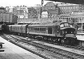 British Railways Type 4 1Co-Co1 D87 is seen entering a nearly complete New Street station's Platform 9 with the 08 35am Pembroke to Derby service