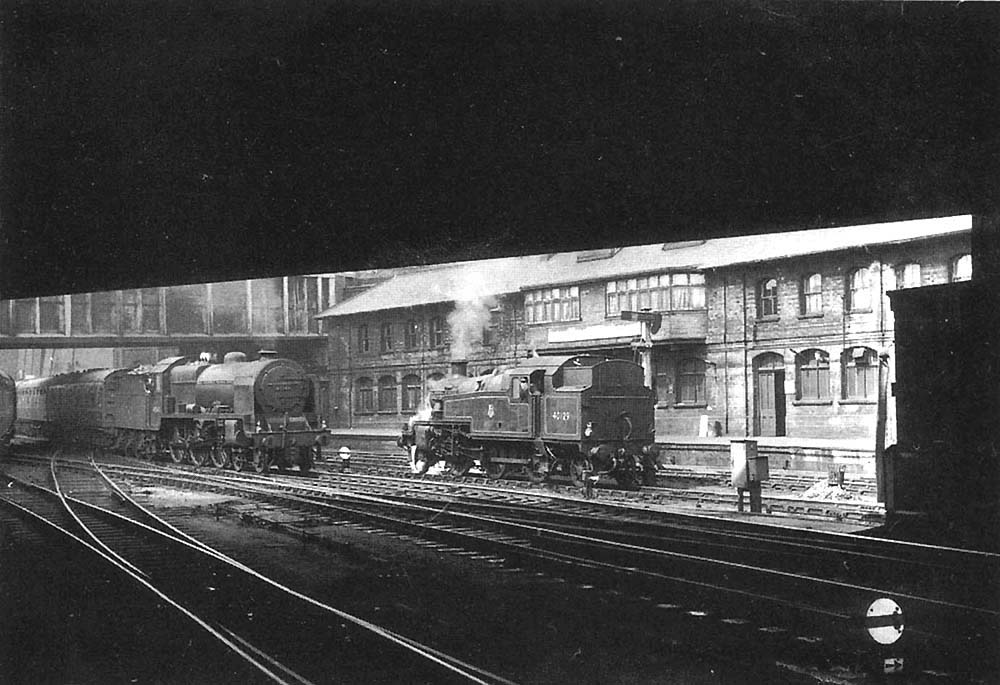 Ex-LMS 4-6-0 Patriot class No 45543 'Home Guard' is seen passing ex-LMS 3MT 2-6-2T No 40129 between Navigation and Hill Street bridges