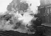 Ex-LMS 5XP 4-6-0 Jubilee class No 45741 'Leinster' is seen smothered in steam on a wet and foggy Spring day as it heads the 10 20am up express service to Euston