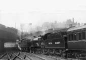 Ex-Midland Railway 4P 4-4-0 Compound No 41035 and exLMS 4P 4-4-0 Compound No M935 are seen leaving the West end of Platform 9 at the head of a Bristol express